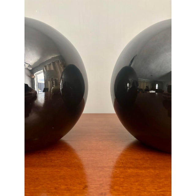 Beautiful pair of gloss black post modern vases. In great vintage condition. Simple shape with a striking bold finish. The...