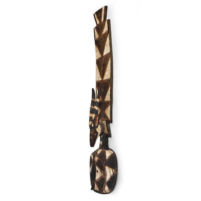 A striking sculptural piece with rich cultural heritage, this tall antelope plank mask from Burkina Faso features an...