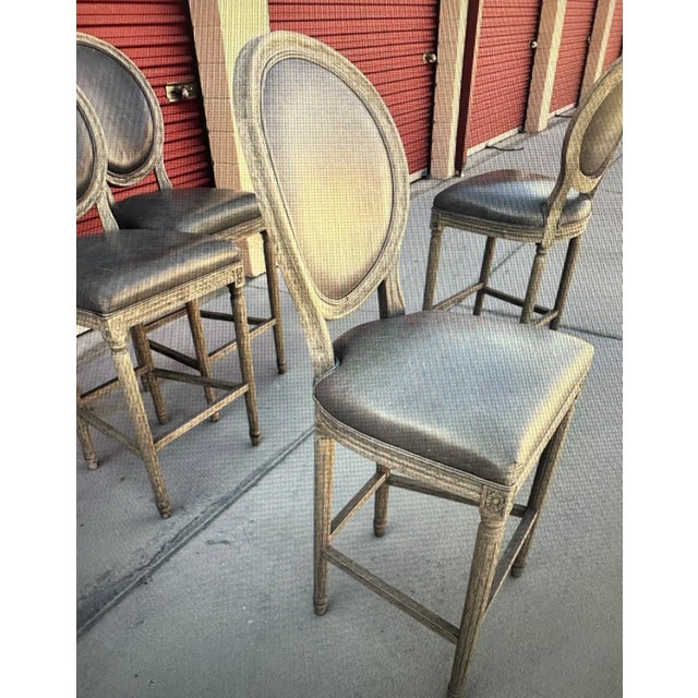Set of Restoration Hardware French Contemporary Round Leather Bar Stool Features a round back and angled back legs Frame...