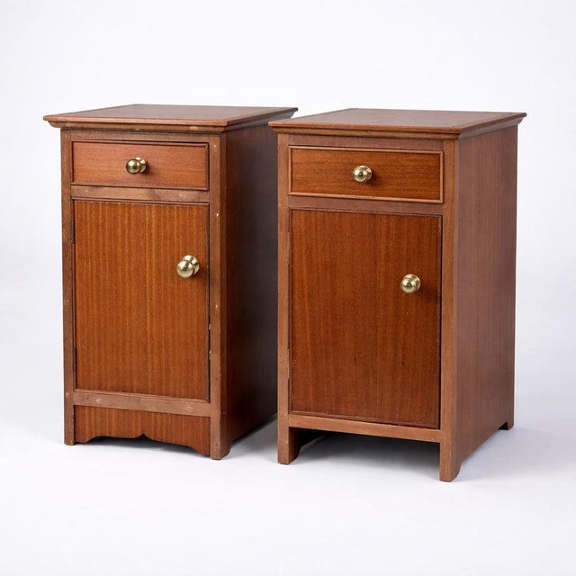 A charming pair of mid century bedside cabinets, finished in a warm-toned wood and designed with simple, practical...