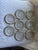 A set of 8 sterling silver rimmed coasters. The sterling silver rims are a floral repousse pattern over a pressed glass...