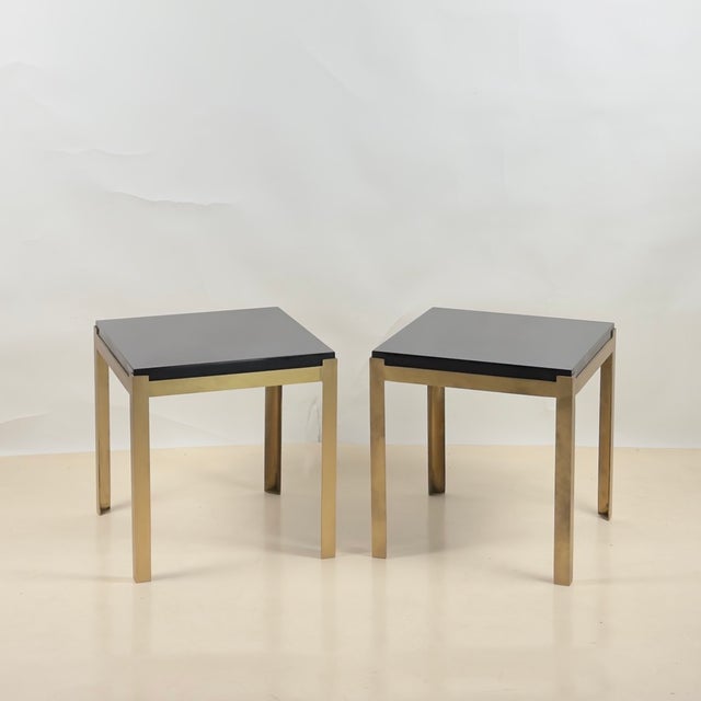 Pair of small 'Caisson' black lacquer and brushed brass side tables by Design Frères. Perfect next to low armchairs or an...