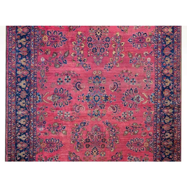 An incredible early 20th century Persian Sarouk Mohajeran rug with an all-over mirrored floral cluster pattern woven in...