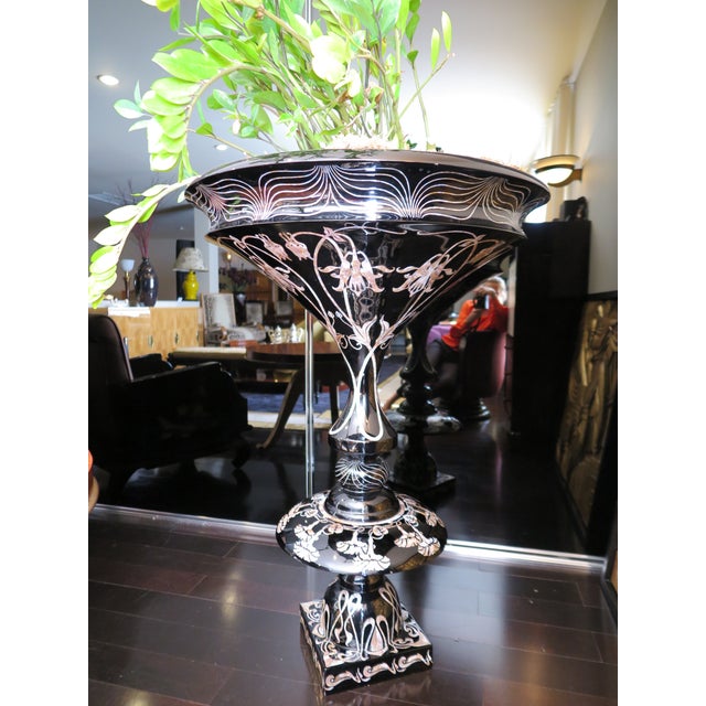 Life-size planter in black lacquer with intricate mother of pearl detailing throughout in floral and organic motifs....