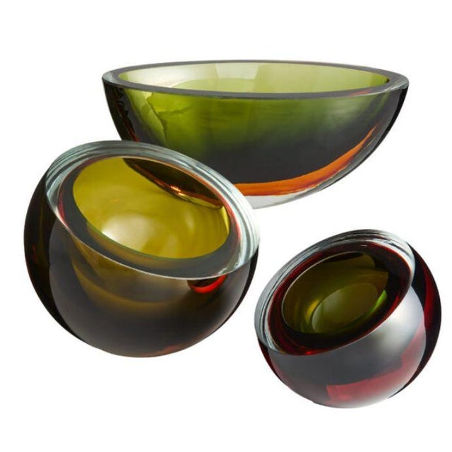 Pluto bowl expertly handblown art glass and features striking layering in rich green and orange hues. It's bold design...