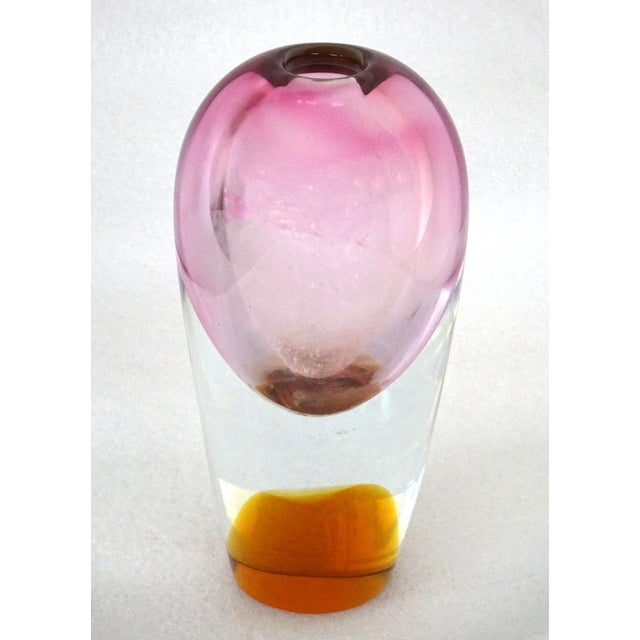 A pink coloured glass vase with an orange hue at the base, of Austrian origin. 9 x 20 cm.