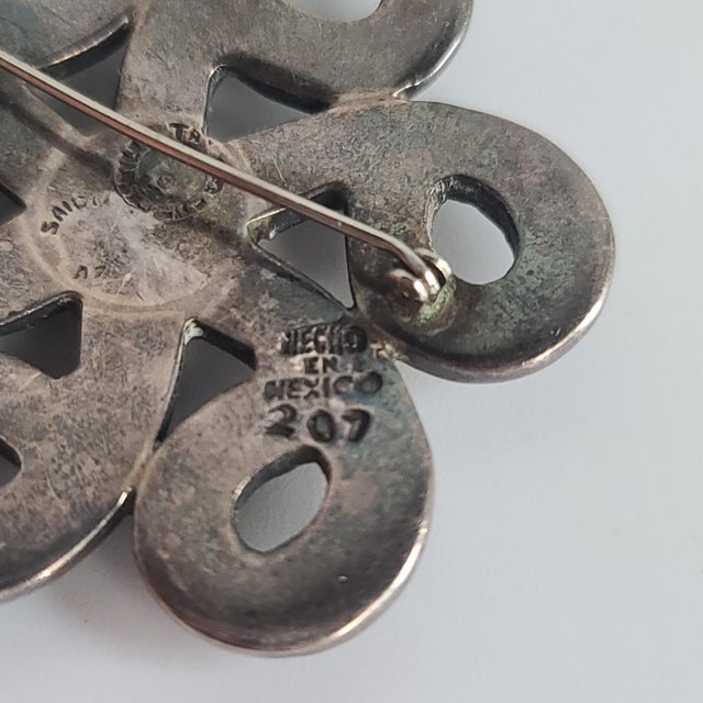 This one-of-a-kind Los Castillo Mexico Turquoise Malachite Lapis Swirl Sterling Brooch is the eye-catching piece your...