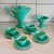 An elegant tea and coffee service comprising a coffee pot, a milk jug, and four cups and saucers in glazed ceramic. The...