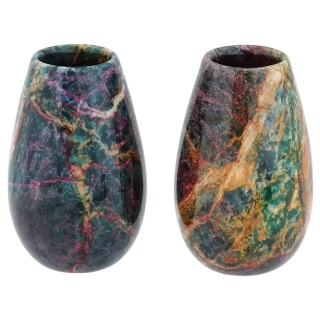 A pair of vases made of jasper. Each a similar, elongated, polished, tear drop shape, with an open top. The vases feature...