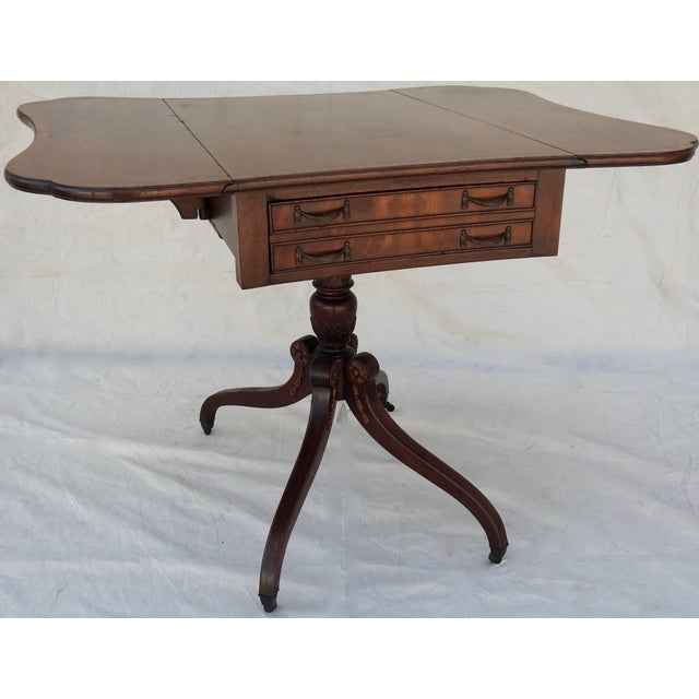 We are offering a unique butterfly shaped drop-leaf table. It is made of walnut with the edges trimmed with inlay. The one...