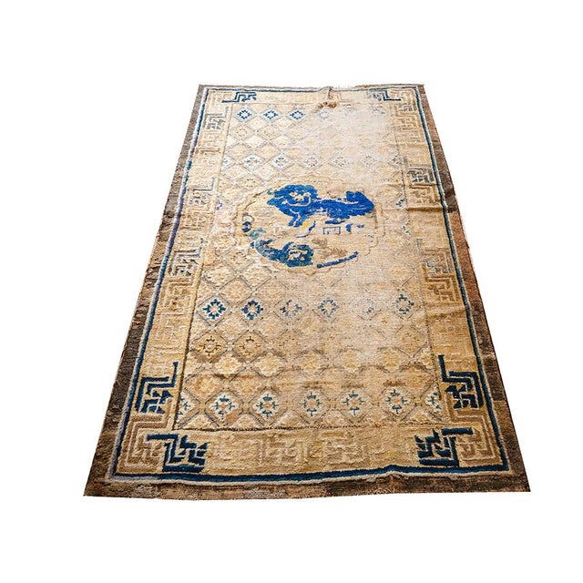 This circa 1880 Chinese Ningxia rug a vibrant yellow field, measuring 3' 8" x 6' 8". It is characterized by a soft,...