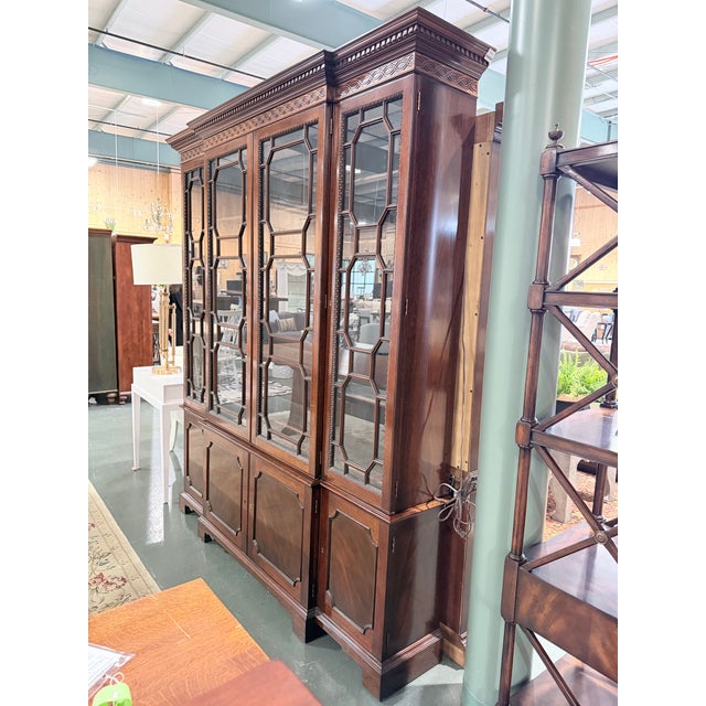 An exceptional Kindel Winterthur breakfront cabinet exhibiting the distinguished craftsmanship and classical architectural...