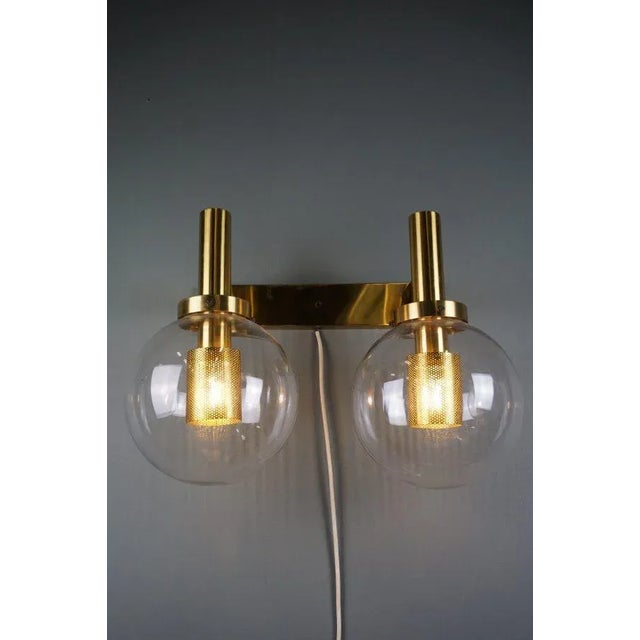 Due to its beautiful glass balls and brass fixture, this lamp has a soft look when in fire and is therefore a true eye...