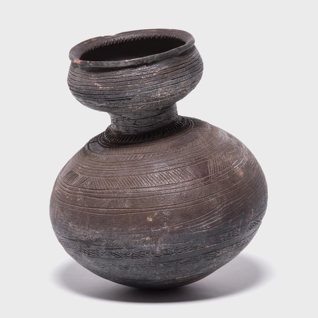 Inspired by the natural world, Nupe ceramicists fired this water vessel in the shape of a gourd. The vessel's varied...