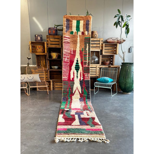 This Moroccan Boujad runner rug is an authentic handwoven piece from the Middle Atlas region, distinguished by its bold...
