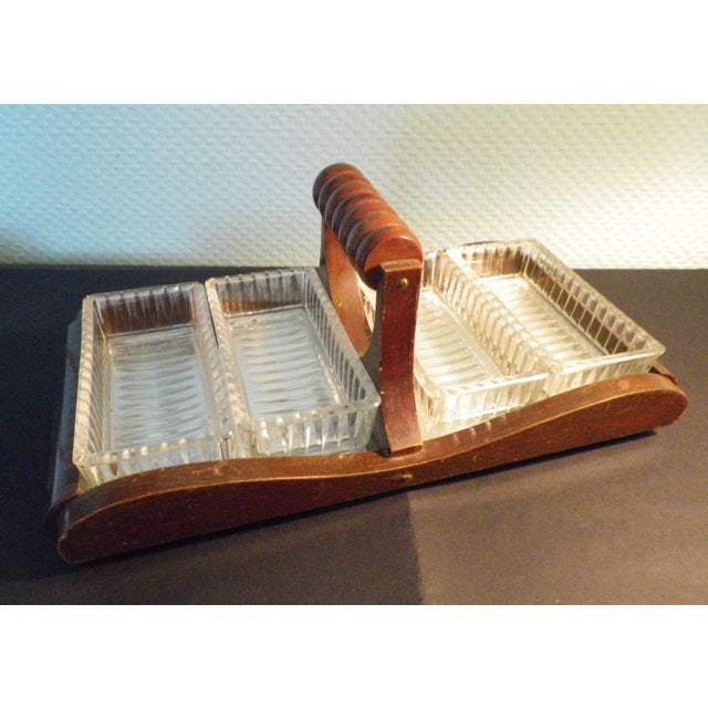 A 1950s serving set. The four compartments are made of thick, clear glass with a textured back and a smooth interior. The...