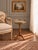 This vintage French gueridon side table features a beautifully veined marble top framed by a pierced brass gallery and...