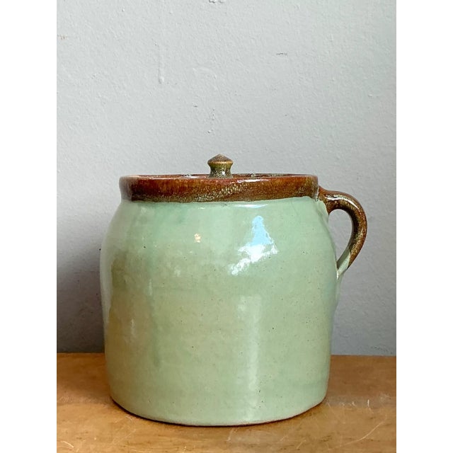 This vintage handcrafted ceramic storage jar from Maine combines a rounded form with the practical detail of a fitted lid...