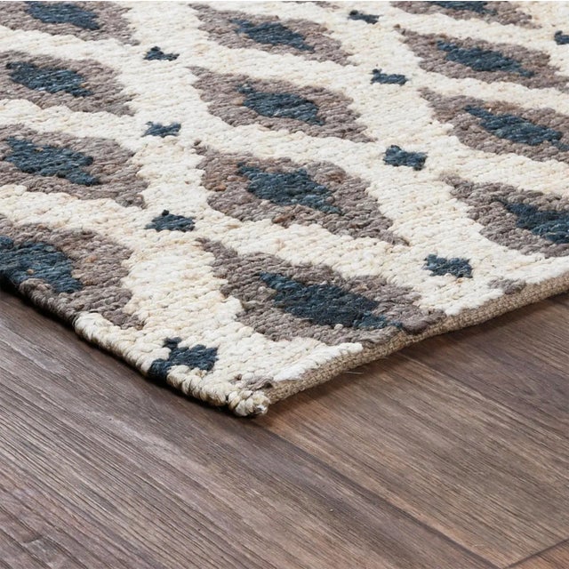 Handwoven jute rug with beautiful gray/taupe and indigo diamond patterning on contrasting ivory background. For medium...