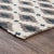 Handwoven jute rug with beautiful gray/taupe and indigo diamond patterning on contrasting ivory background. For medium...