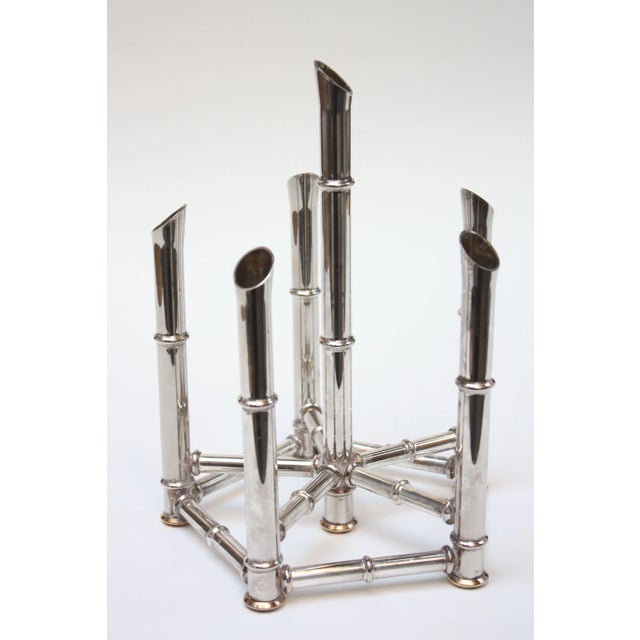 Striking chrome plated candle-holder designed to accommodate six candles. Brass circular bottom fittings add a nice color...