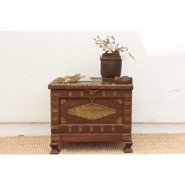 Chart a course for distinctive style with this captivating vintage teak and brass trunk, a piece that whispers tales of...