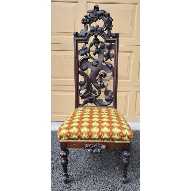 Offered is a striking pair of Black Forest or Renaissance Revival side chairs. This pair features elaborate pierced...