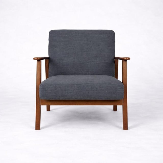 A stylish vintage 1990s ikea lounge armchair, featuring a clean scandinavian design with a solid teak frame and...