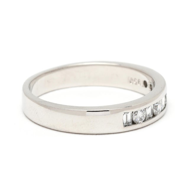 Stones: diamond round brilliant cut, 4 2.5 mm .25ctw baguette, 5 2.25 x 1.75 mm .25ctw FG color/ VS2-SI1 clarity Ring Size...