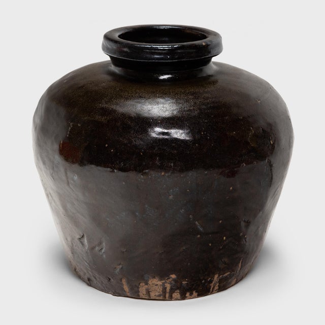 Originally used for fermenting rice or sorghum into wine or vinegar, this squat, earthenware vessel from the early 20th...