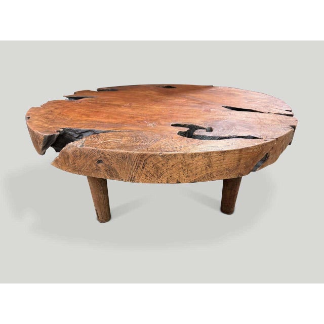"Impressive ancient teak wood coffee table floating on mid century style cone legs and finished with a natural oil...
