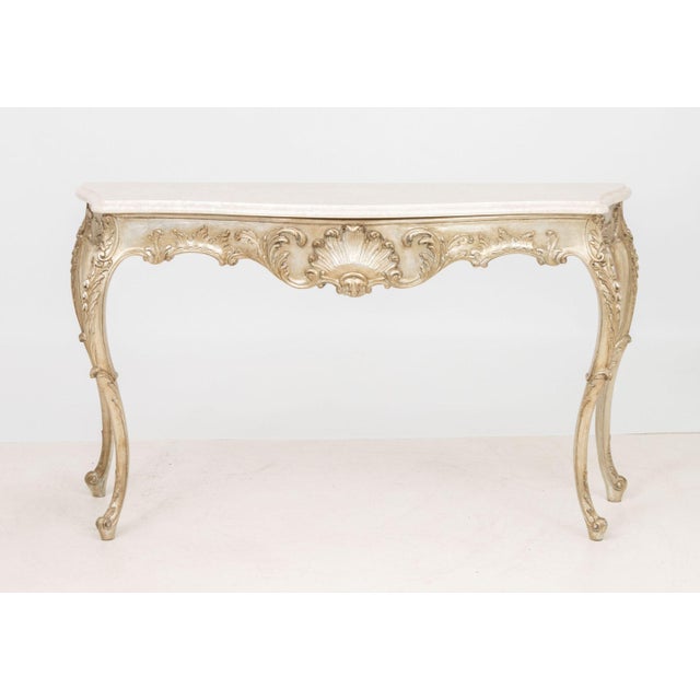 Italian Rococo Style Silvered Wood Console Table, with white stone top, the base ornately carved with shell rocaille...