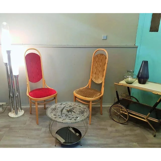 Pair dining chairs made of beech wood with a high backrest. Signed by Thonet, 1987. In the style of Arts & Crafts, Art...