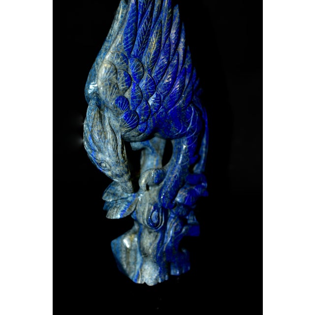 A masterfully hand-carved sculpture of a majestic eagle, rendered in richly saturated natural lapis lazuli. Carved from a...