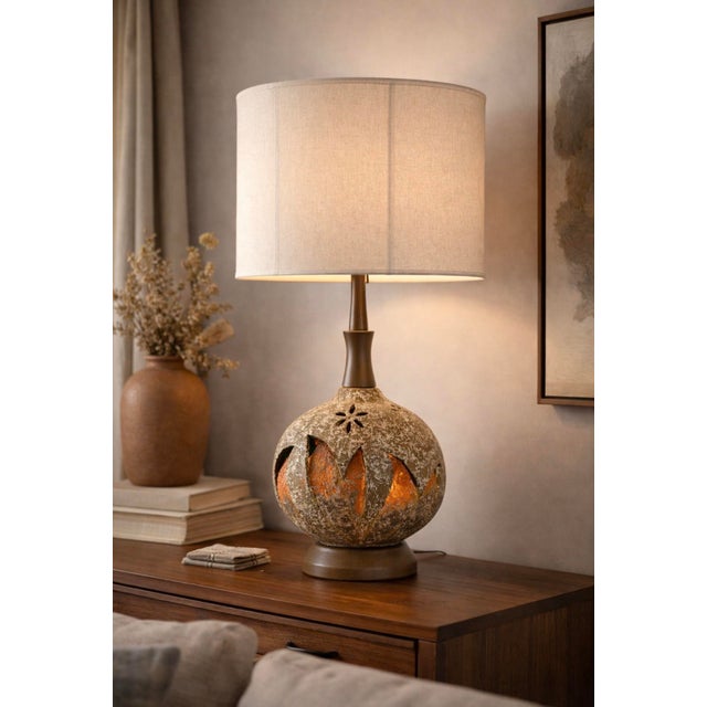 Sculptural mid-century modern ceramic table lamp with Brutalist influences, featuring a heavily textured, pierced body...