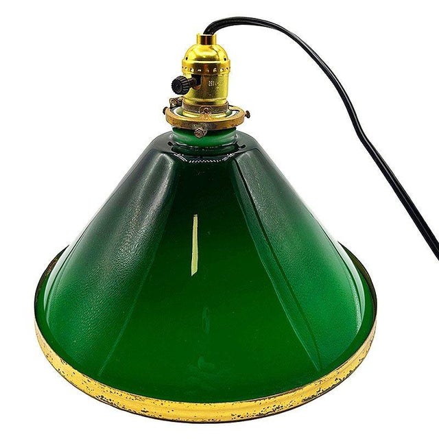 1920 industrial pendant lamp features a striking large 11" cone-shaped shade in emerald green glass, finished with brass...