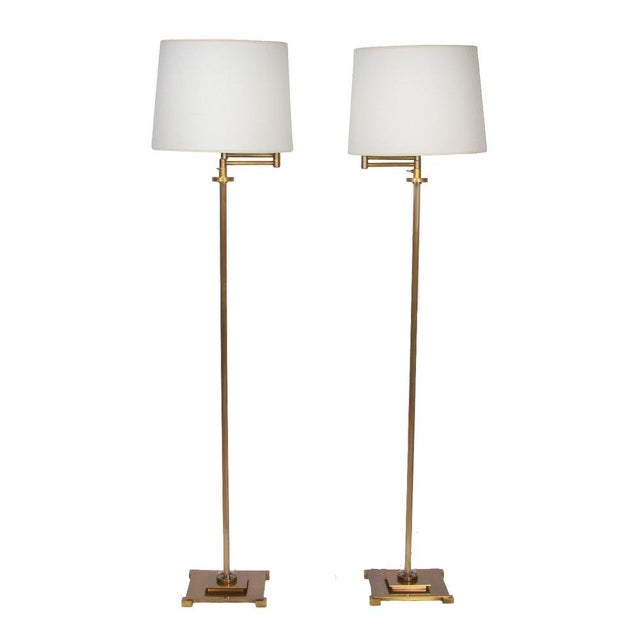 A timeless blend of form and function, this pair of modern adjustable floor lamps showcases sleek brass construction with...