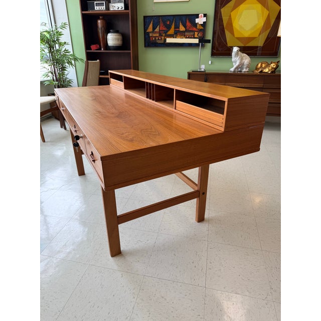 Offering a terrific Danish modern teak executive flip top desk designed by Peter Lovig Nielsen for Dansk of Denmark, Circa...