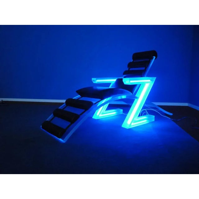 Club armchair made in Italy. The armchair comes from St. Moritz Switzerland. In the armrests there are functional neon...
