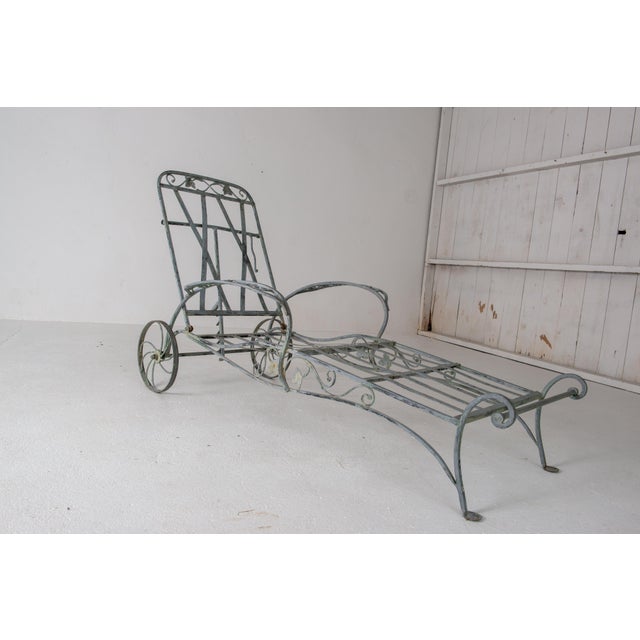 This is a Hollywood Regency mid 20th century wrought iron chaise lounge designed and manufactured in the USA by legendary...