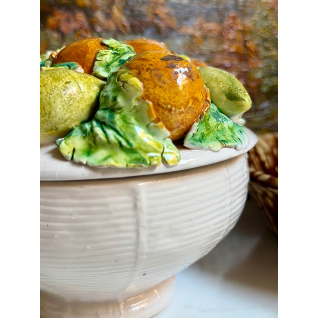 A vibrant Italian majolica-style lidded jar designed as a topiary, decorated with hand-painted lemons and oranges. The...