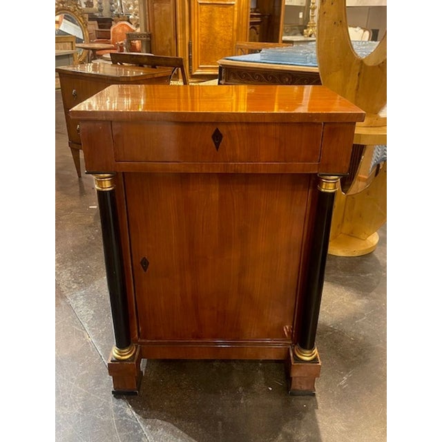 The 19th c. German Biedermeier Walnut Side Cabinet is a stylish and elegant piece . Made of high-quality walnut material,...