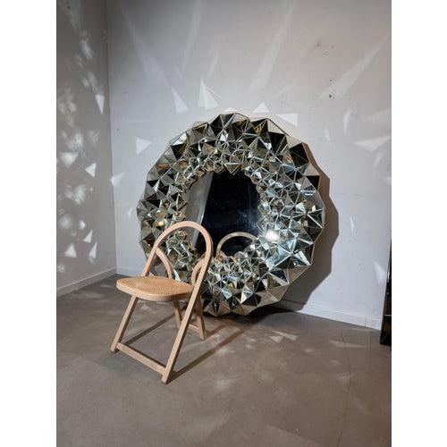 Impressive XL sunburst mirror featuring a spectacular three-dimensional frame composed of faceted mirrored panels. The...