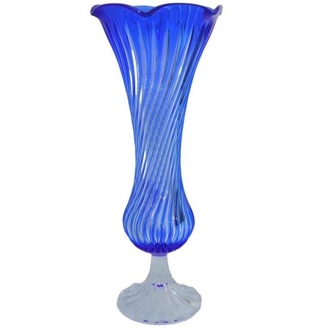 Midcentury blue crystal vase with elegantly hand-cut swirled motif and intricate details. No maker's mark. This beautiful...