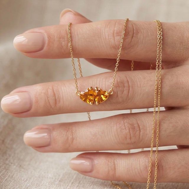 Warm up your jewelry collection with this sun-kissed two-stone pendant necklace, featuring two sparkling golden-yellow...