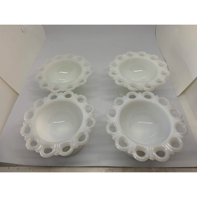 4 Small footed milk glass bowls on short pedestals. Perfect for fruit or desserts. Features an open edge lace border...