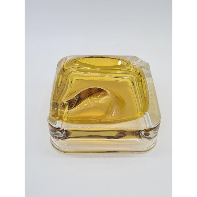 An elegant, substantial ashtray made of Italian art glass, most likely from Murano, using the striking sommerso technique....