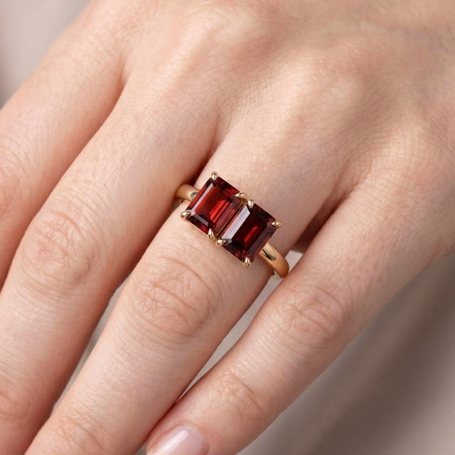 Deep, passionate, and strikingly bold, this exquisite Toi et Moi ("You and Me") ring features a parallel pair of emerald-...