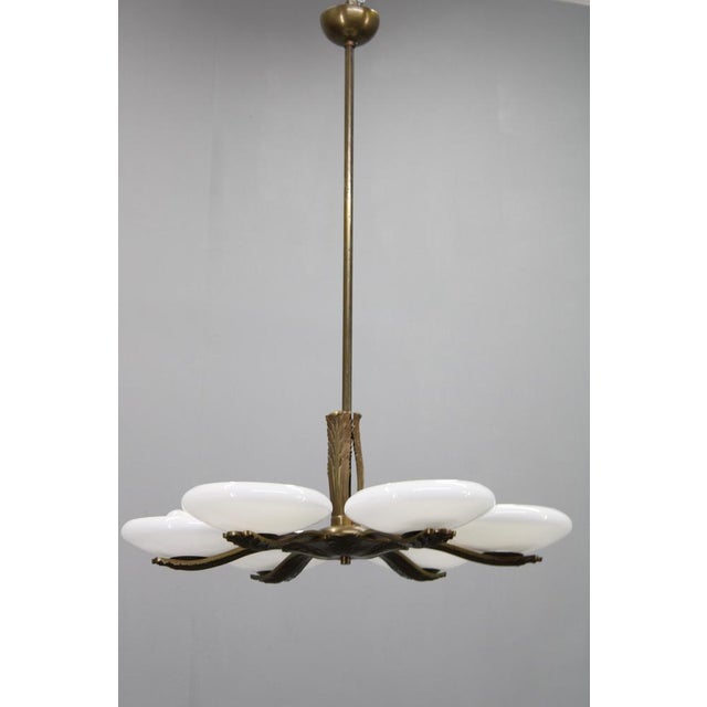 This elegant art deco chandelier was produced in czechoslovakia in the 1930s. Crafted from solid brass and fitted with six...