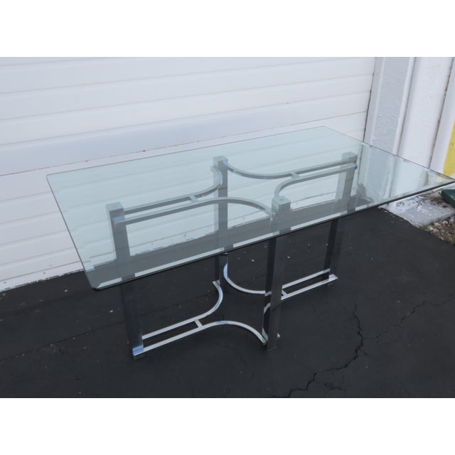 This Dining Table is made out of metal, and glass. The Dining Table has a interesting Hollywood Regency style and design,...